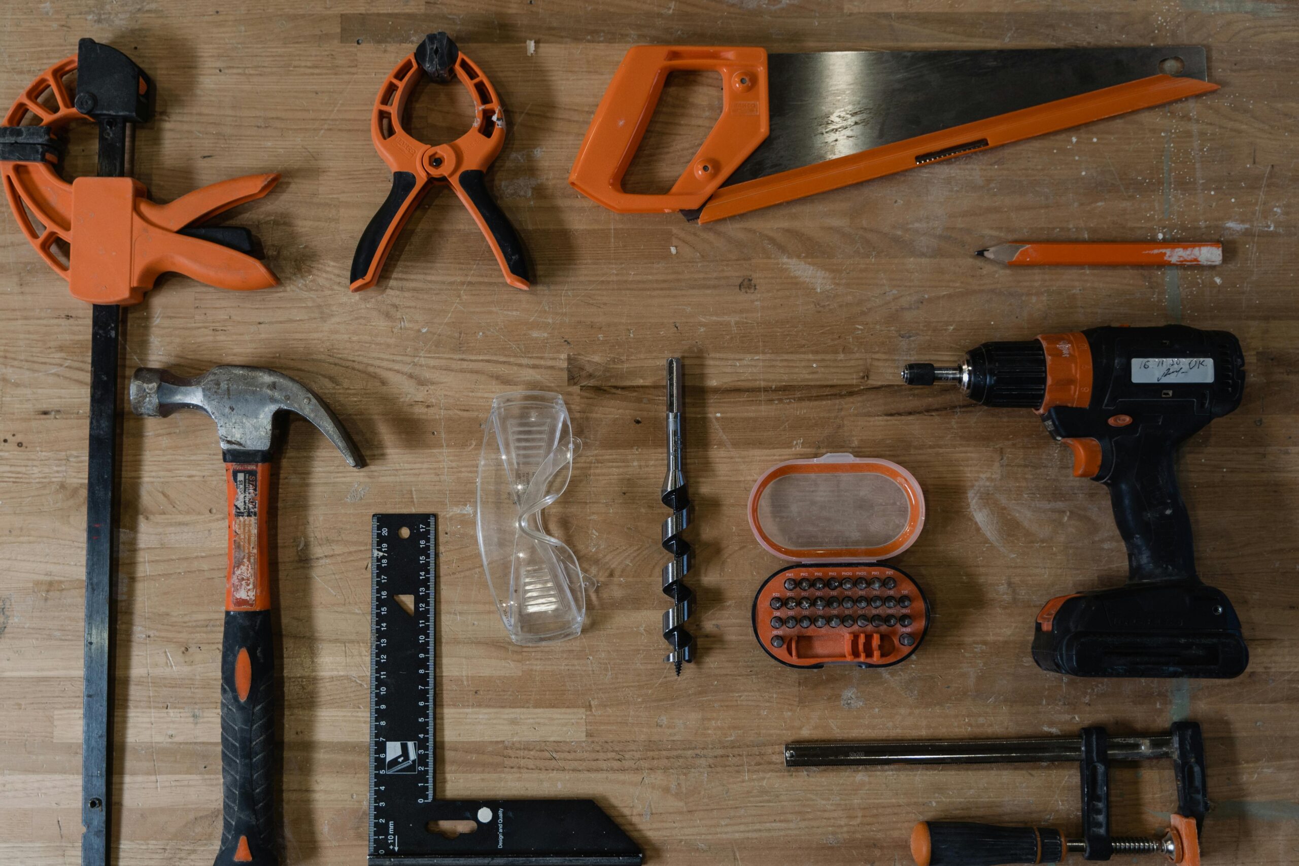 A variety of carpentry tools arranged neatly on a wooden surface, ideal for DIY projects.